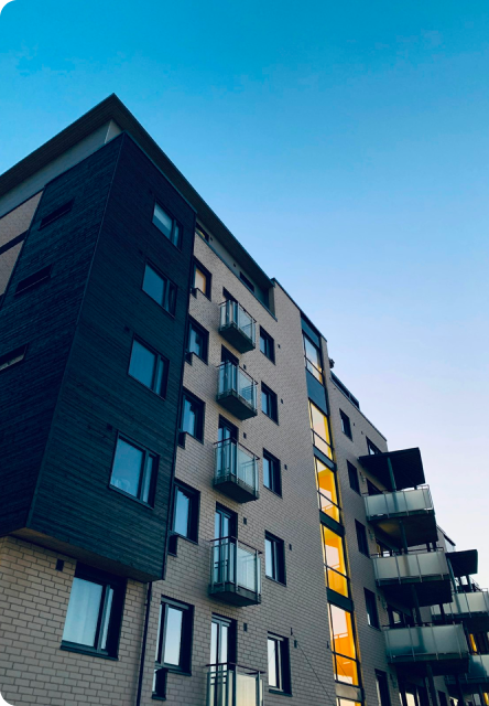 Modern residential building facade against a blue sky